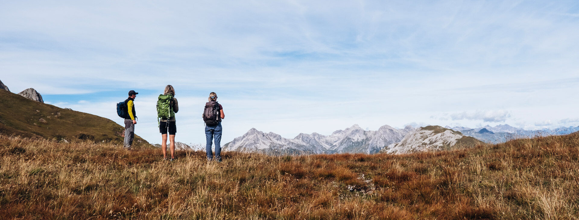 Drei Wanderer in Herbstlandschaft